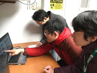 3 scientists reviewing data on a computer