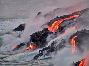 This is a photo of an interplay of water and lava streams as sun comes up.
